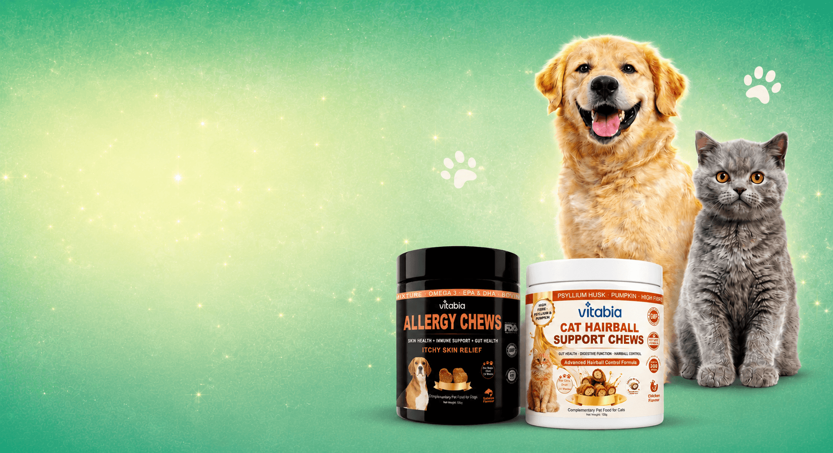Two pet supplement containers from Vitabio are displayed against a green gradient background with a golden retriever and a gray cat standing behind them. The products are Vitabio Allergy Chews for dogs and Cat Hairball Support Chews for cats.
